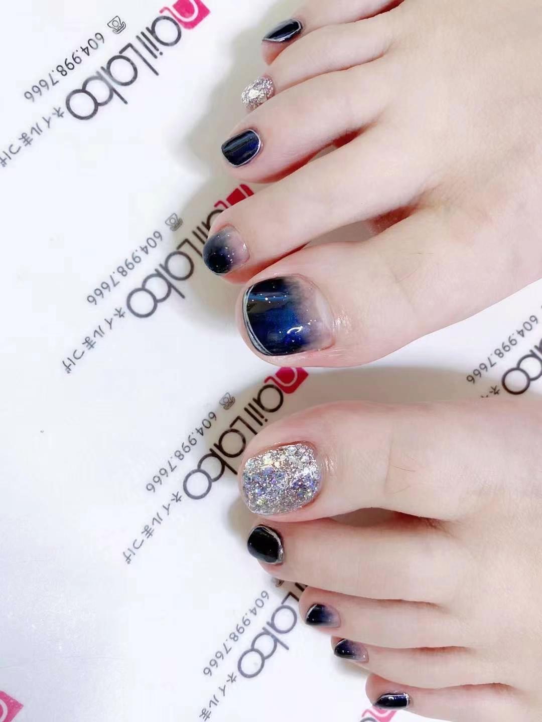 Ombre pedicure design with glitter accents